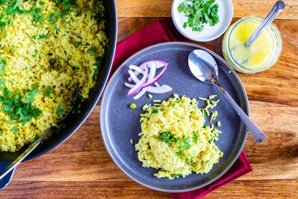 Khichri, Indian porridge served on a plate with yogurt and salad on the side