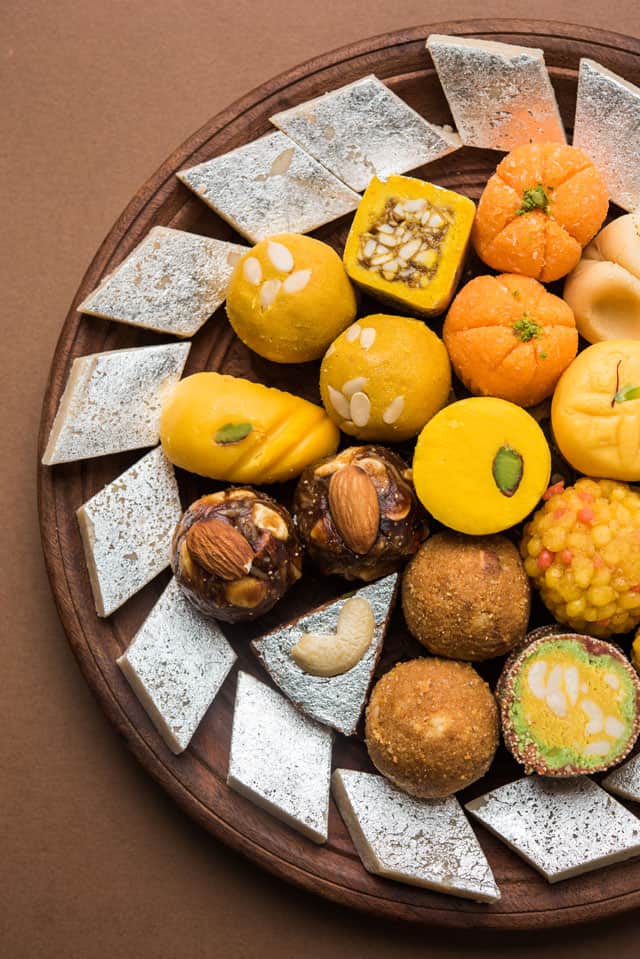 various Indian Sweets on a large brown platter