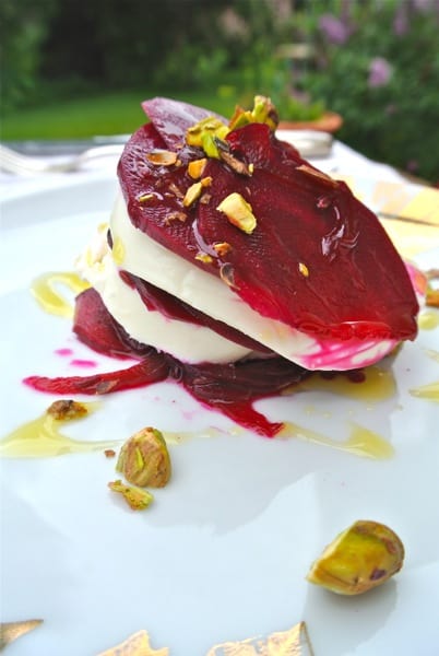 sliced quick pickled beets layered with fresh cheese on a plate