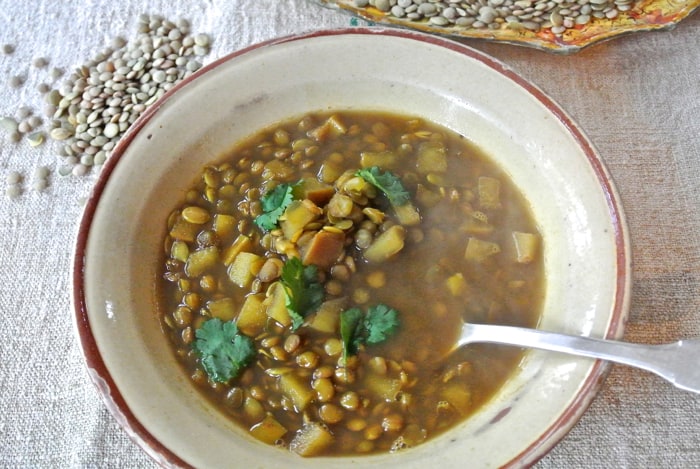 dal soup in a white bowl with a spoon