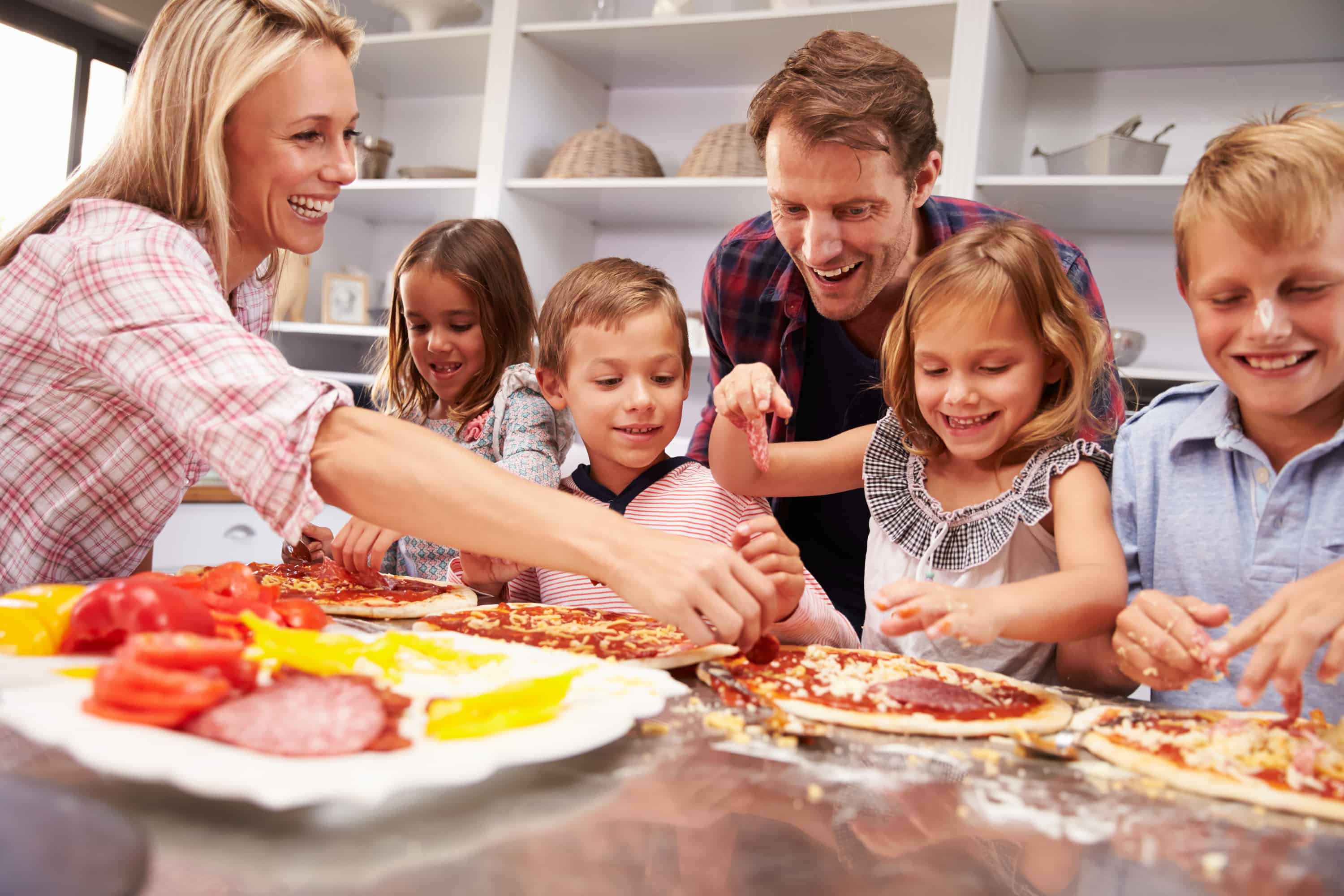 pizza night, family cooking together to make their own pizzas