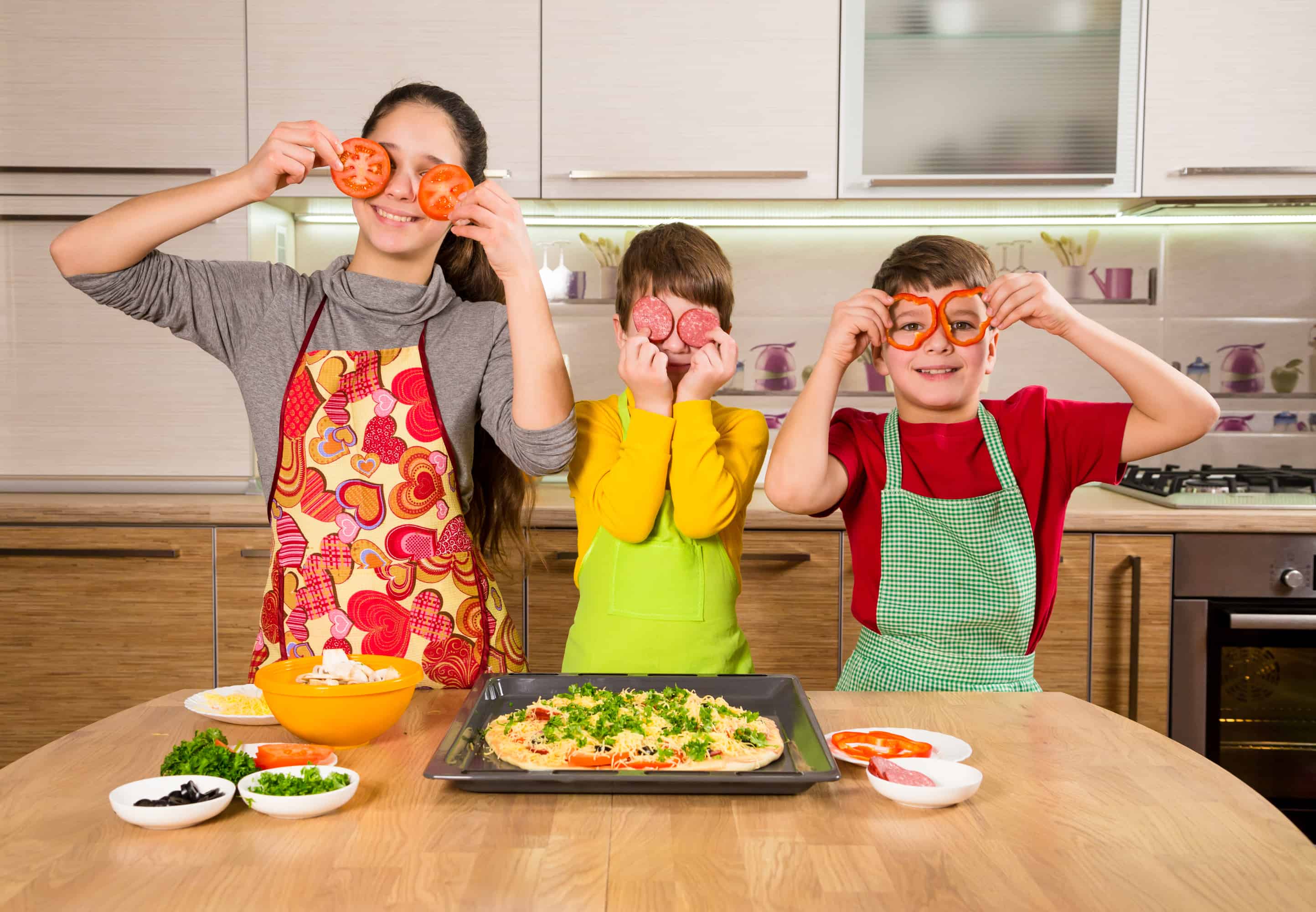 three kids having fun cooking their own meal