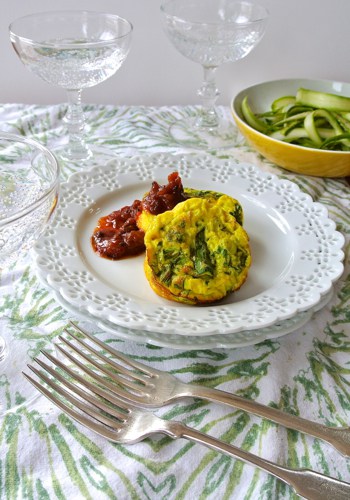 two mini quiche on a plate with tomato chutney