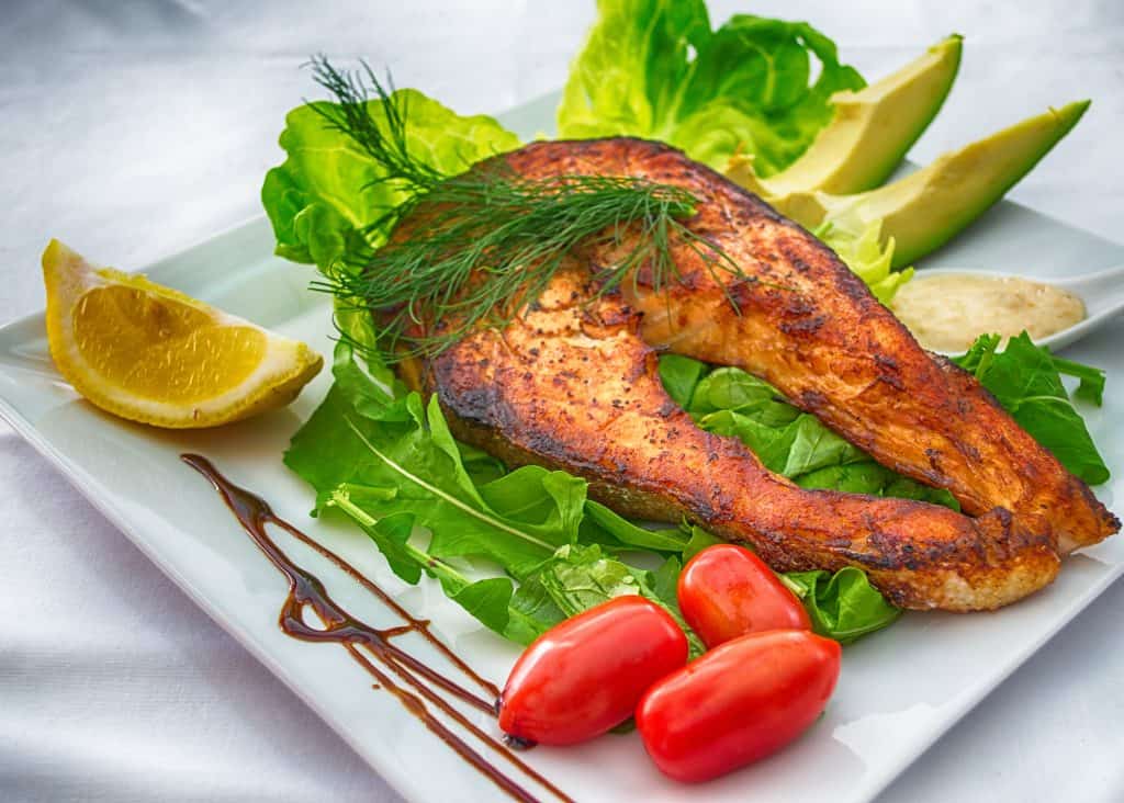 green salad and veggies served with fish