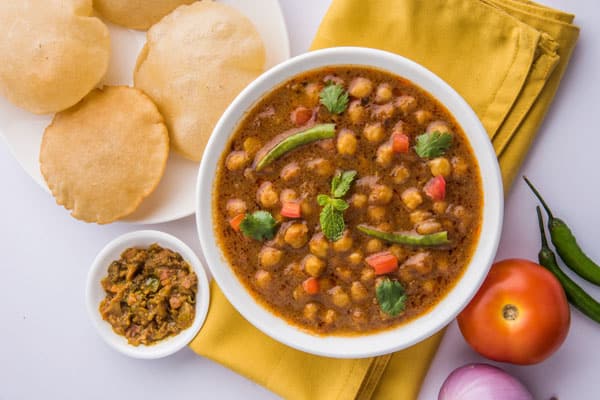 Chana Masala Served with Indian bread and condiments