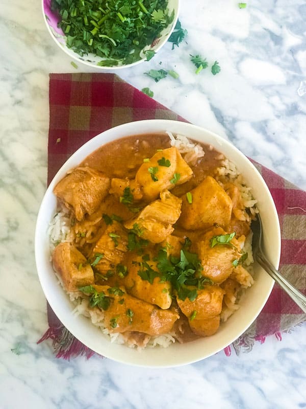 Chicken Tikka Masala served over rice and garnished with cilantro