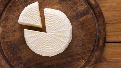 Homemade Paneer on a wooden board.