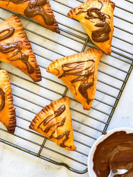 Choclate samosa with molten chocolate on the side.