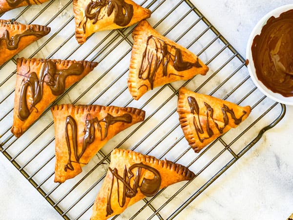 Choclate samosa with molten chocolate on the side.